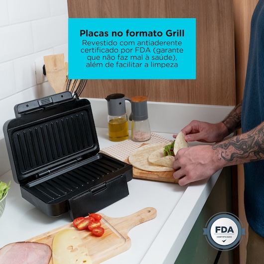 Black+Decker grill press open, food and ingredients nearby, FDA certified nonstick plates, person preparing wrap.