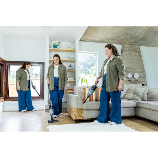 BLACKDECKER AV15 stick vacuum in use by a person cleaning different areas in a modern living room.