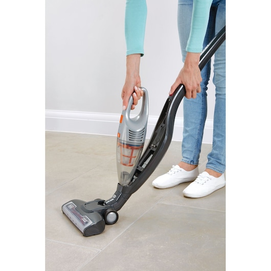 Photo of BLACKDECKER AV160 vacuum cleaner, handheld model shown being removed from upright base on tile floor.