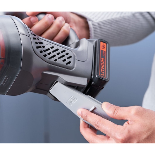 Photo of BLACKDECKER BCHV001D1E cordless vacuum cleaner handle and battery, hand attaching accessory.