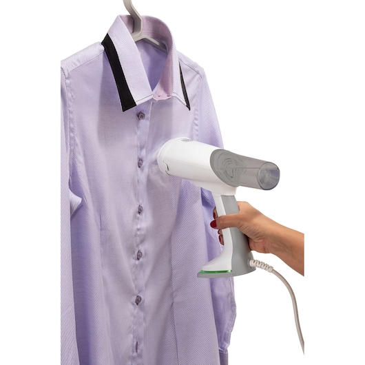 BLACKDECKER BDV3000 handheld garment steamer in use on a light purple shirt, white background, product side view.
