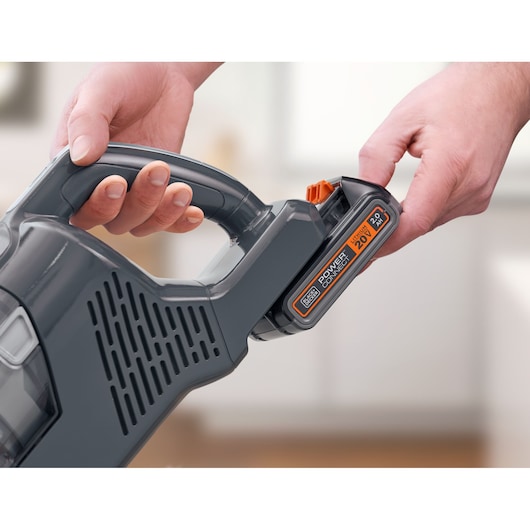 Photo of BLACKDECKER BHFEA18D1 cordless vacuum handle showing battery removal.