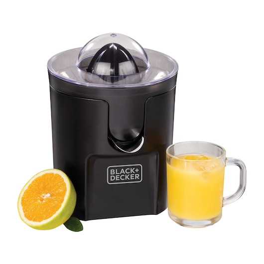 A BLACK+DECKER citrus juicer with a black body and transparent lid. To the left, there is a half-cut orange. To the right, there is a glass mug filled with orange juice and ice.