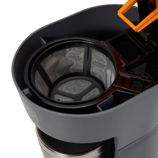 BLACKDECKER CM01 coffee maker close-up showing mesh filter and grey plastic housing.