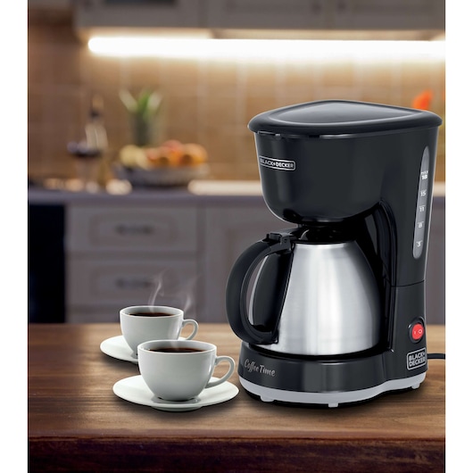 BLACKDECKER CM15 coffee maker with stainless steel carafe, two cups of coffee, kitchen background.