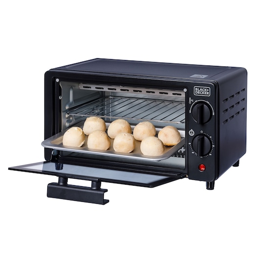 BLACK+DECKER FT9N toaster oven, black, front angle, with a tray of bread rolls inside.