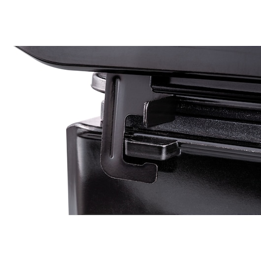 Photo of BLACKDECKER G1200 metal clip detail on black appliance, close-up angle.