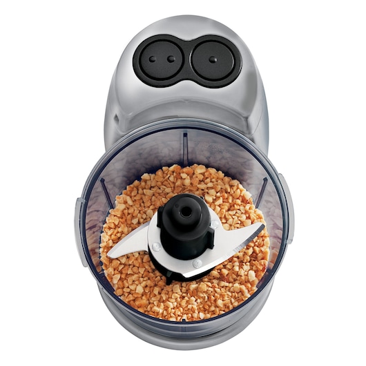 BLACKDECKER HC32P food chopper with dual button control, stainless steel blade, top view filled with chopped nuts.
