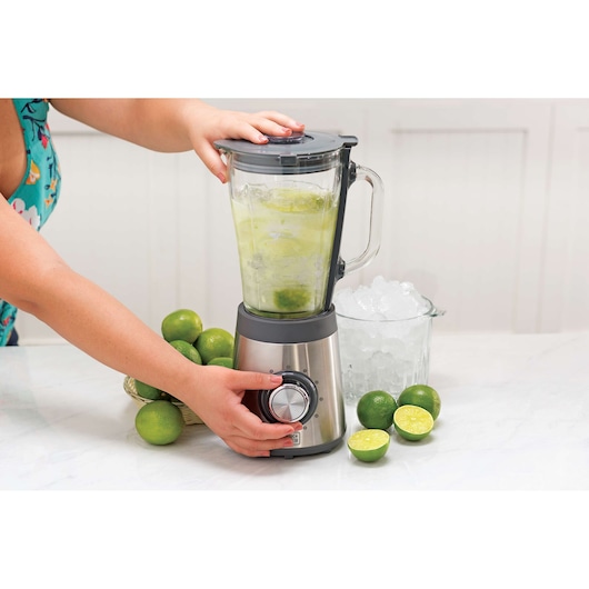 BLACKDECKER L7000G blender in use with limes and ice on a kitchen counter, close-up side angle.