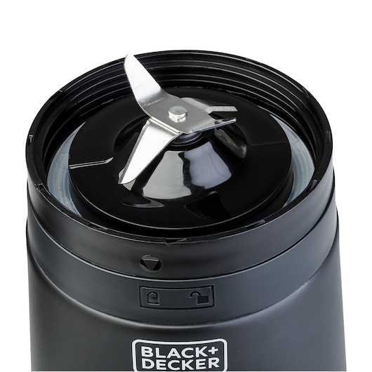 Close-up of the blade assembly on a BLACK+DECKER blender or grinder, showing sharp stainless steel blades and locking mechanism.