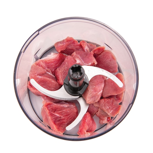 BLACKDECKER meat grinder bowl MP4 with raw meat pieces, top view on white background.