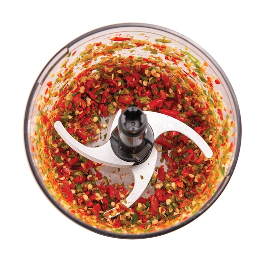BLACKDECKER MP4 food chopper top view with chopped red and green peppers in clear bowl.