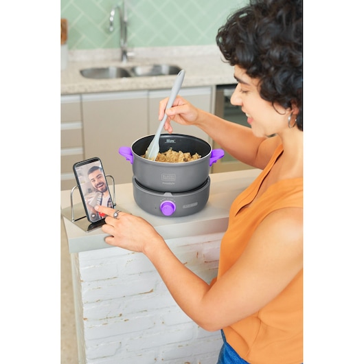 Photo of BLACKDECKER PC700 purple-handle electric pot used for cooking on a kitchen counter.