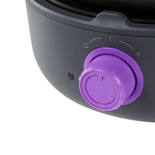 BLACKDECKER PC700 appliance close-up with purple control knob, black and gray housing, angled on white background.