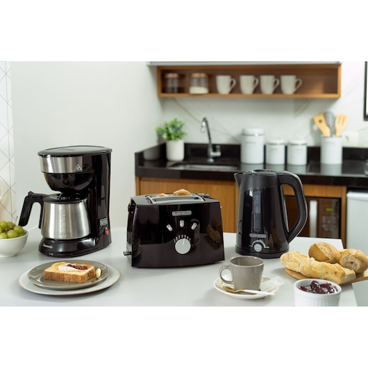 Photography of BLACKDECKER TO810 breakfast set with black coffee maker, toaster, and electric kettle on kitchen counter.